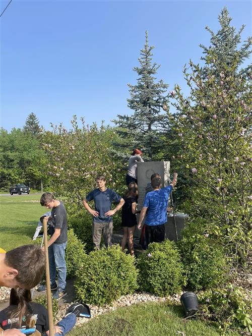 Image of JROTC Cadets cleaning the memorial as detailed in the story.