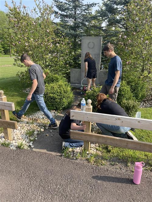 Image of JROTC Cadets cleaning the memorial as detailed in the story.