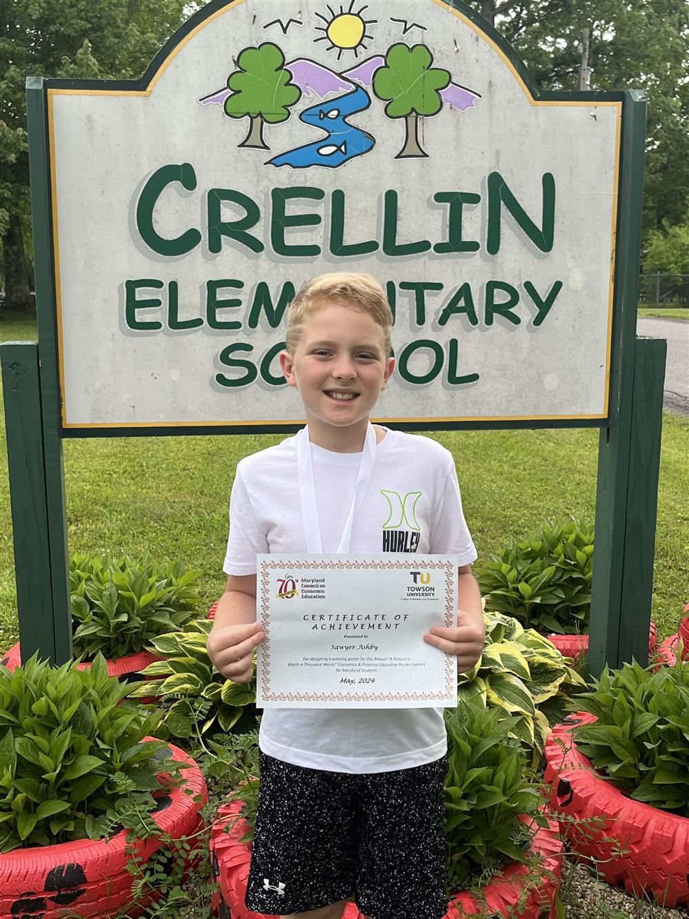Image of a GCPS student holding his recognition certificate.