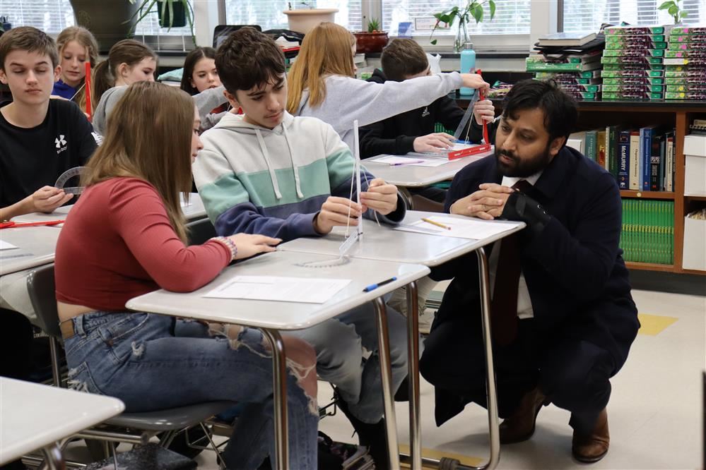 The State Superintendent observes two students working in a science lab classroom.
