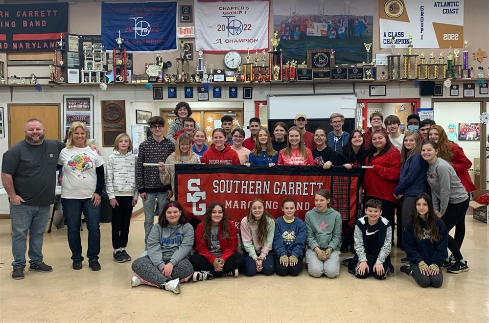  Band members pose for a picture with Mrs. McClosky ahead of their trip.