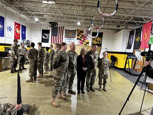 Image of the State Superintendent posing with members of the NGHS JROTC program.