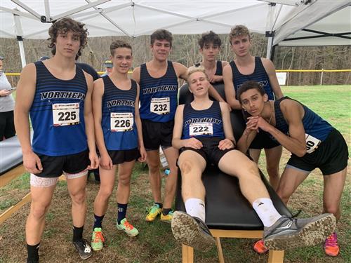 Members of the NGHS Boy's cross-country track team pose for a picture after their race is over.
