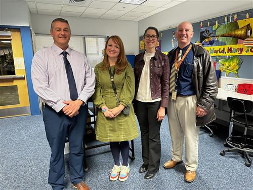 Image of Ali Schilpp, GCPS Teacher of the Year, posed with GCPS Administration.