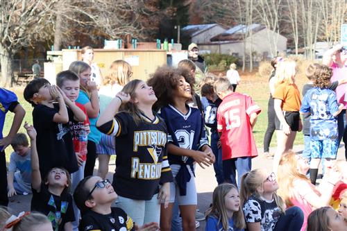 Image of excited students watching a pumpkin drop at Friendsville Elementary.